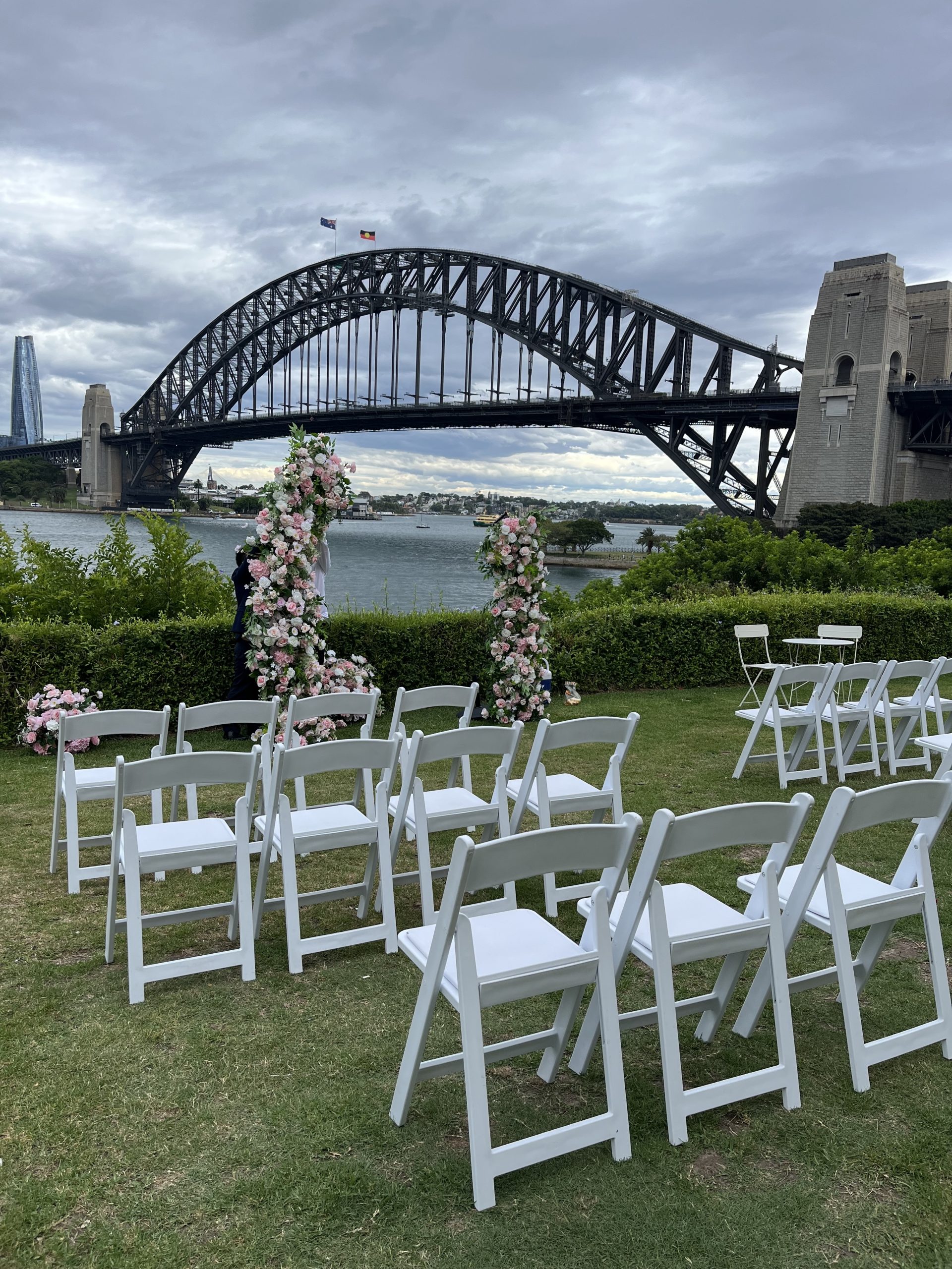 Wedding chair hire Sydney. White folding chairs arranged for an outdoor wedding ceremony in Sydney