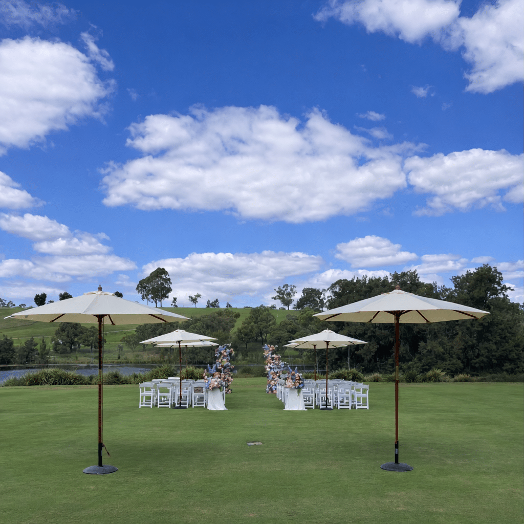 Outdoor wedding ceremony setup at Australian Botanic Garden Mount Annan with white folding chairs and aisle by Budget Event Hire Sydney